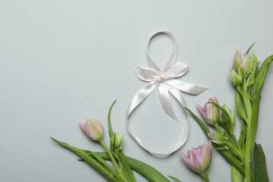Photo of 8 March card design with tulips and space for text on light grey background, flat lay. International Women's Day