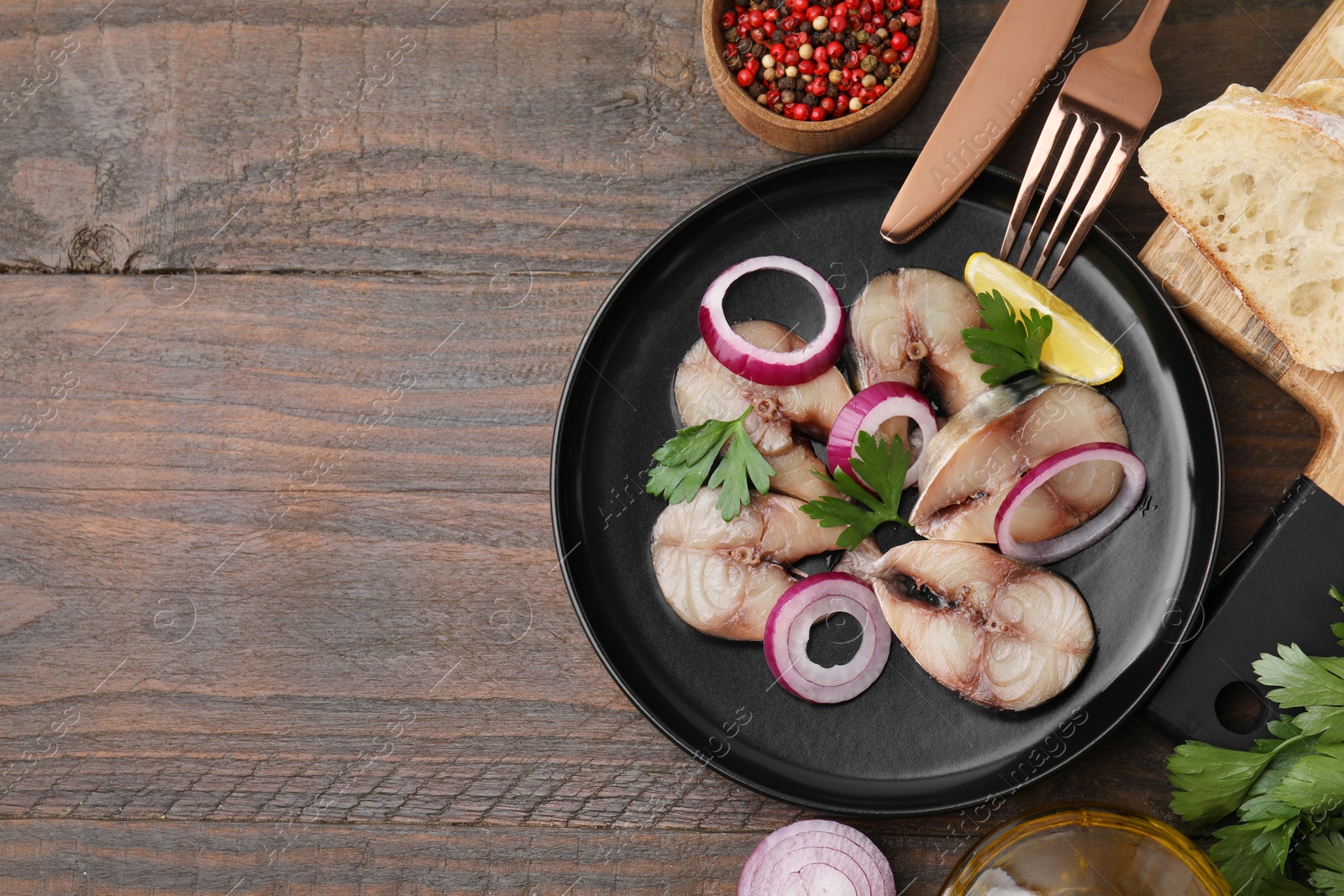 Photo of Slices of tasty salted mackerel served on wooden table, flat lay. Space for text