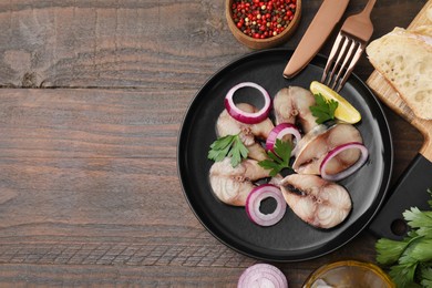 Slices of tasty salted mackerel served on wooden table, flat lay. Space for text