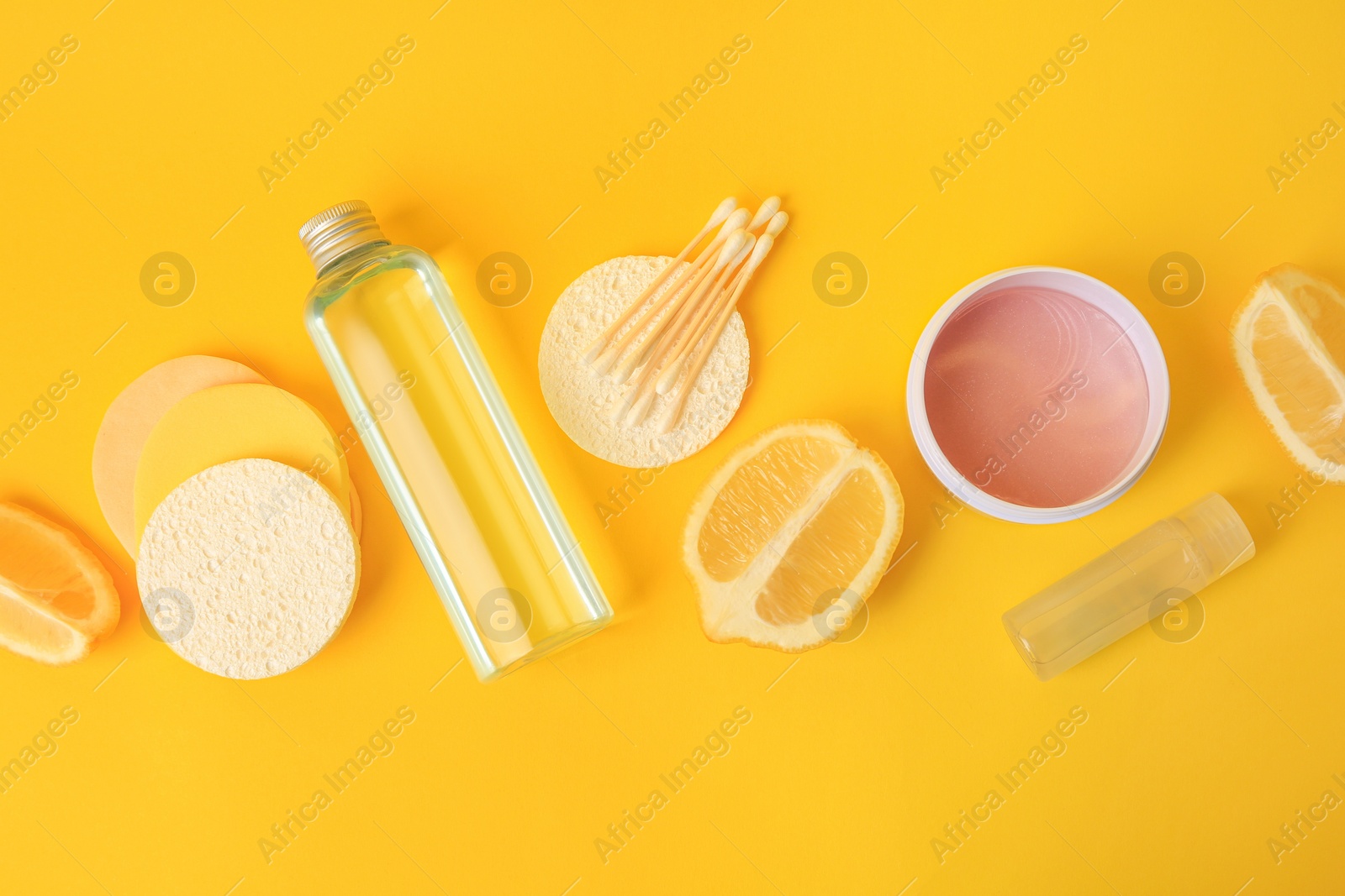 Photo of Lemon face cleanser. Fresh citrus fruits and personal care products on yellow background, flat lay