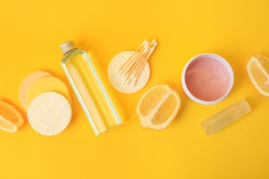 Photo of Lemon face cleanser. Fresh citrus fruits and personal care products on yellow background, flat lay