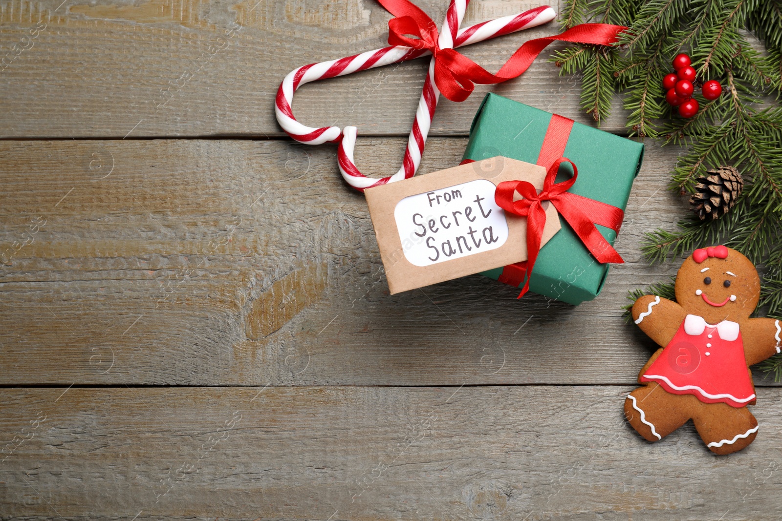 Photo of Flat lay composition with present from secret Santa on wooden table, space for text