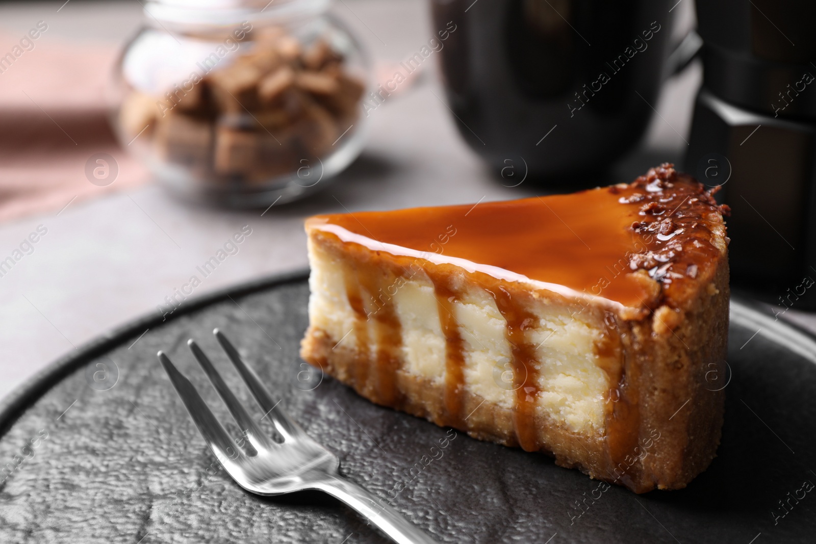 Photo of Piece of delicious cake with caramel served on plate, closeup