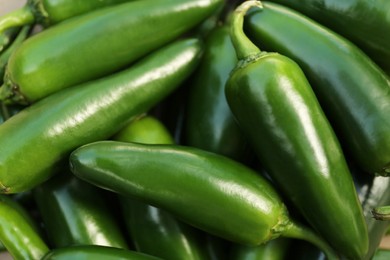 Photo of Green hot chili peppers as background, closeup