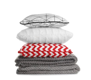 Stylish soft pillows and folded plaids on white background