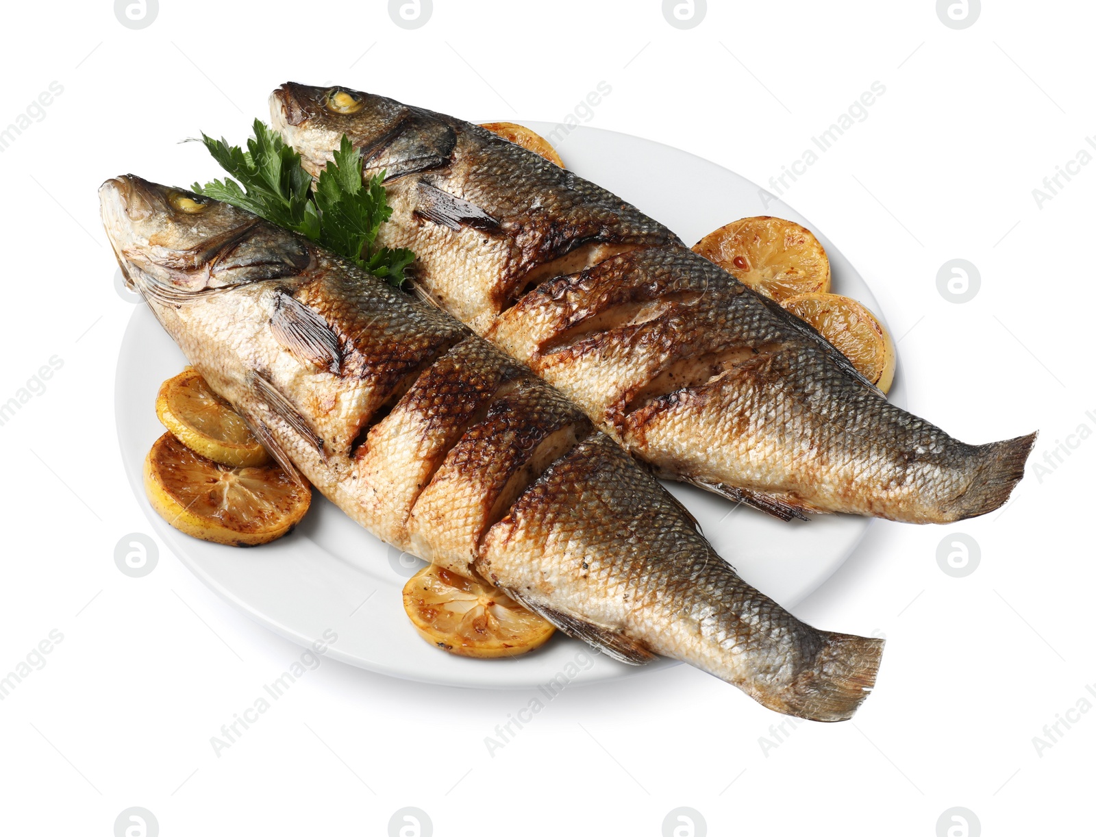 Photo of Plate with delicious sea bass fish, lemon and parsley isolated on white