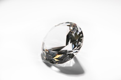 Photo of One beautiful shiny diamond on white background