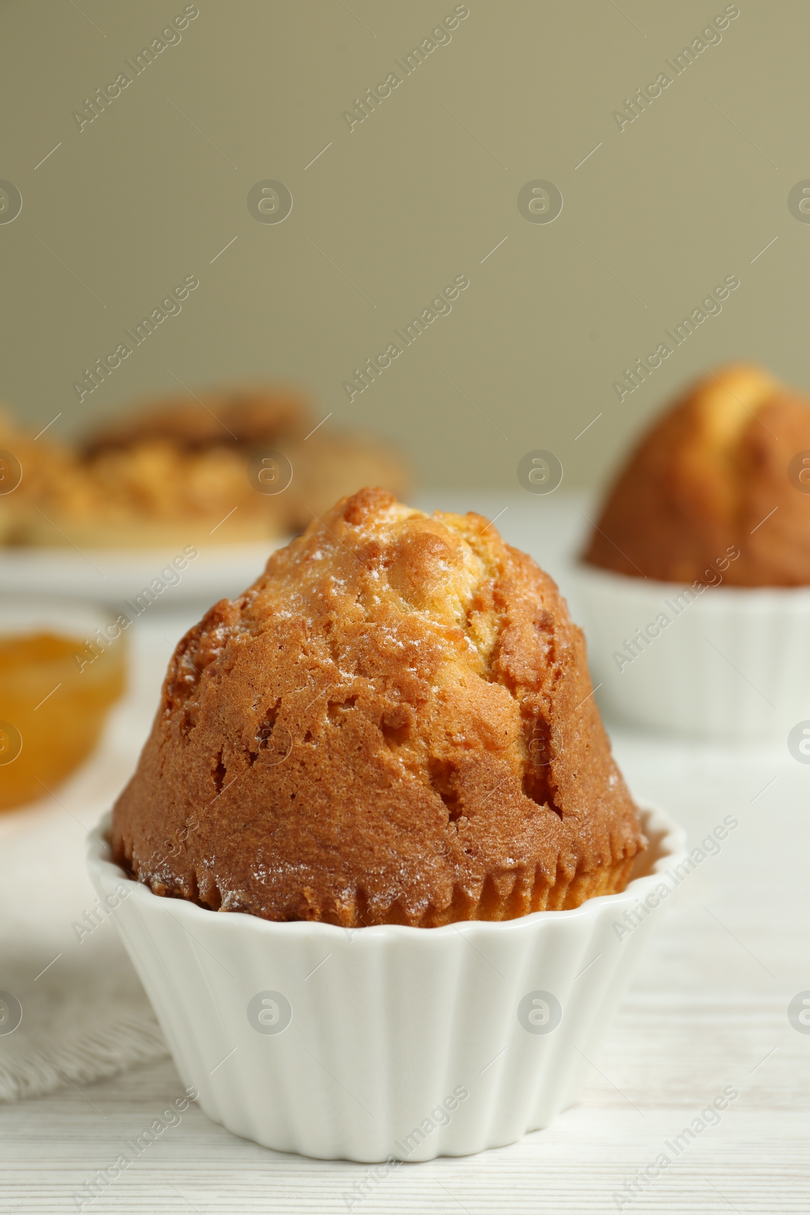 Photo of Delicious sweet muffin on white wooden table