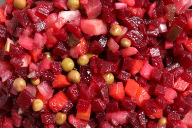 Delicious fresh vinaigrette salad as background, top view