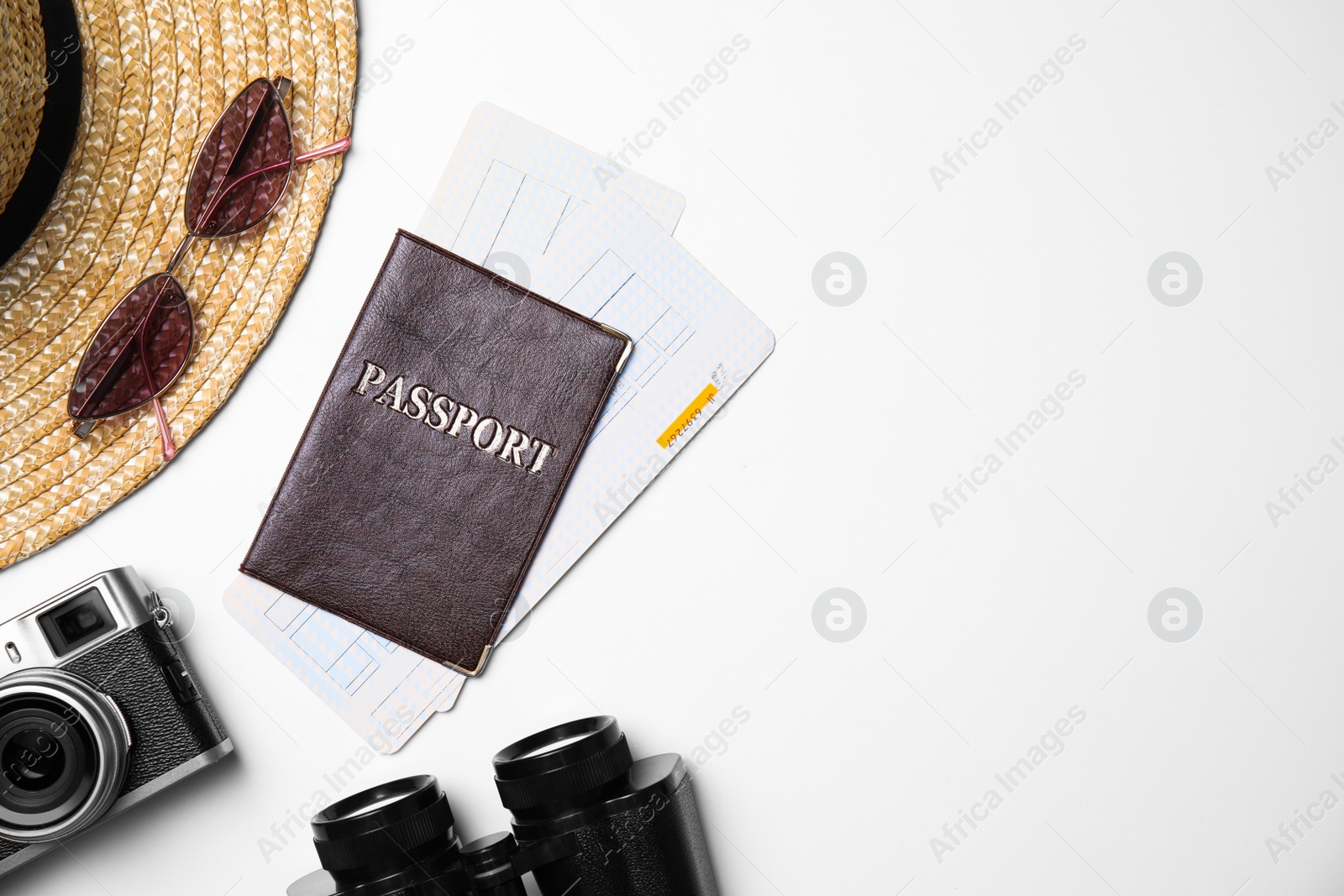 Photo of Flat lay composition with passport, tickets and holiday items on white background. Space for text
