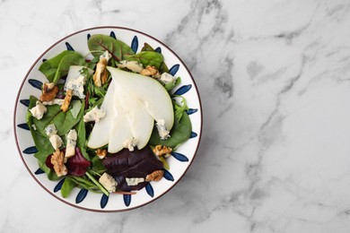 Photo of Delicious pear salad in bowl on white marble table, top view. Space for text