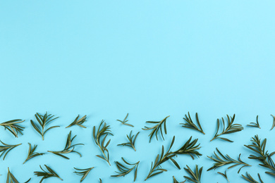 Photo of Flat lay composition with fresh rosemary on light blue background. Space for text