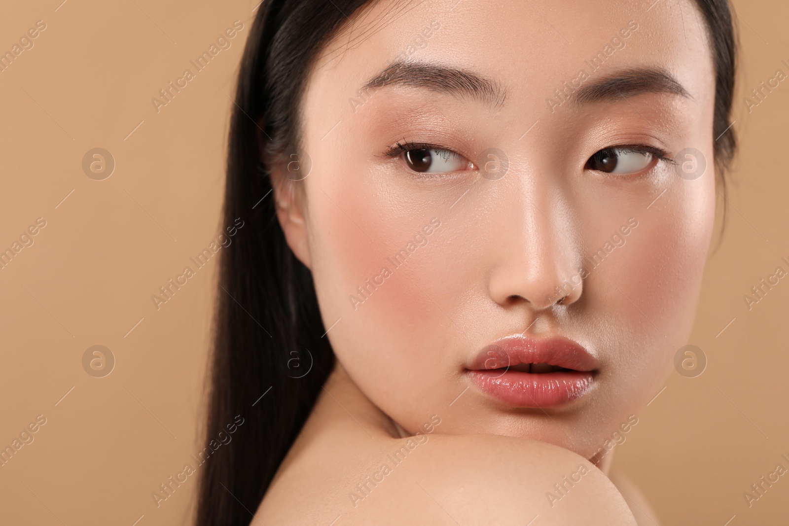 Photo of Beautiful woman with healthy skin on beige background, closeup