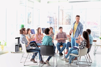 Photo of Male business trainer giving lecture in office