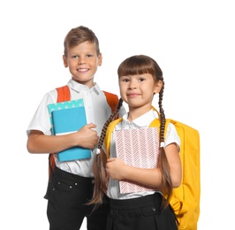 Photo of Little kids with backpacks and notebooks on white background. Stationery for school