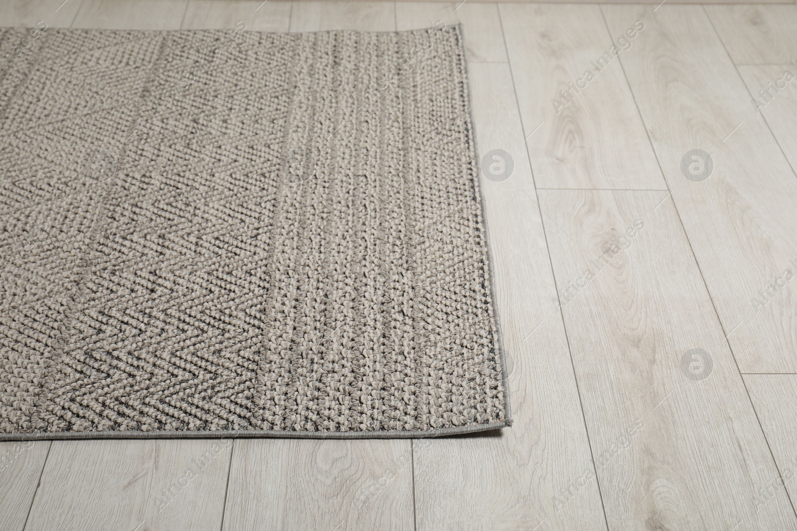 Photo of Soft grey carpet on white laminated floor indoors, space for text