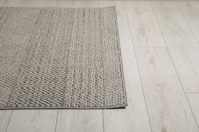 Photo of Soft grey carpet on white laminated floor indoors, space for text