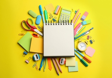 Blank notebook and school stationery on yellow background, flat lay with space for text. Back to school