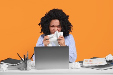 Photo of Stressful deadline. Emotional woman crumpling document at white desk against orange background