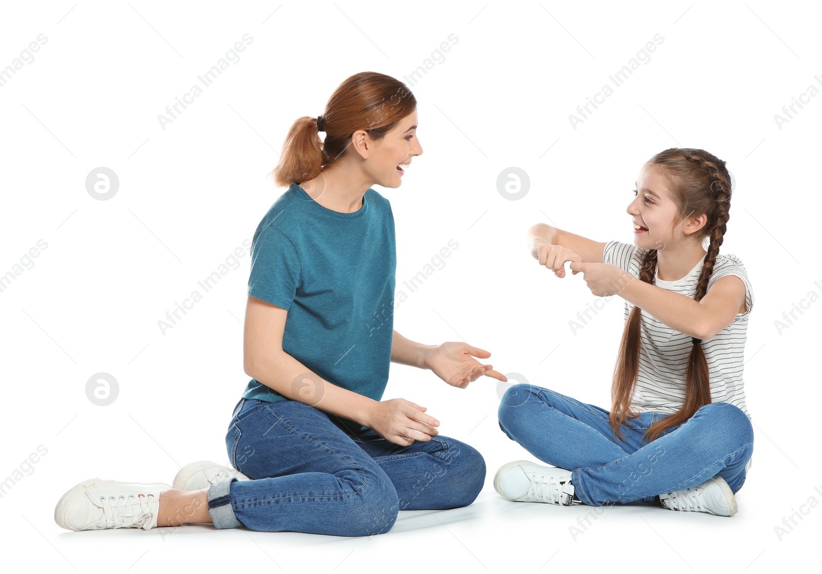 Photo of Hearing impaired mother and her child talking with help of sign language on white background