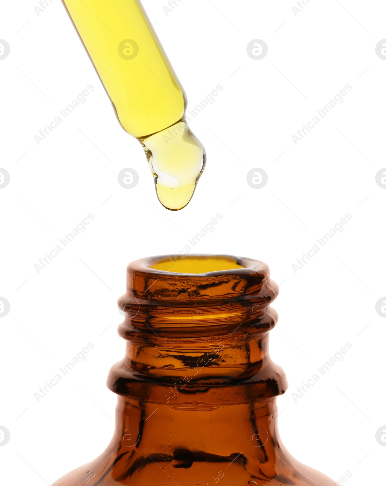 Photo of Dripping tincture from pipette into bottle isolated on white