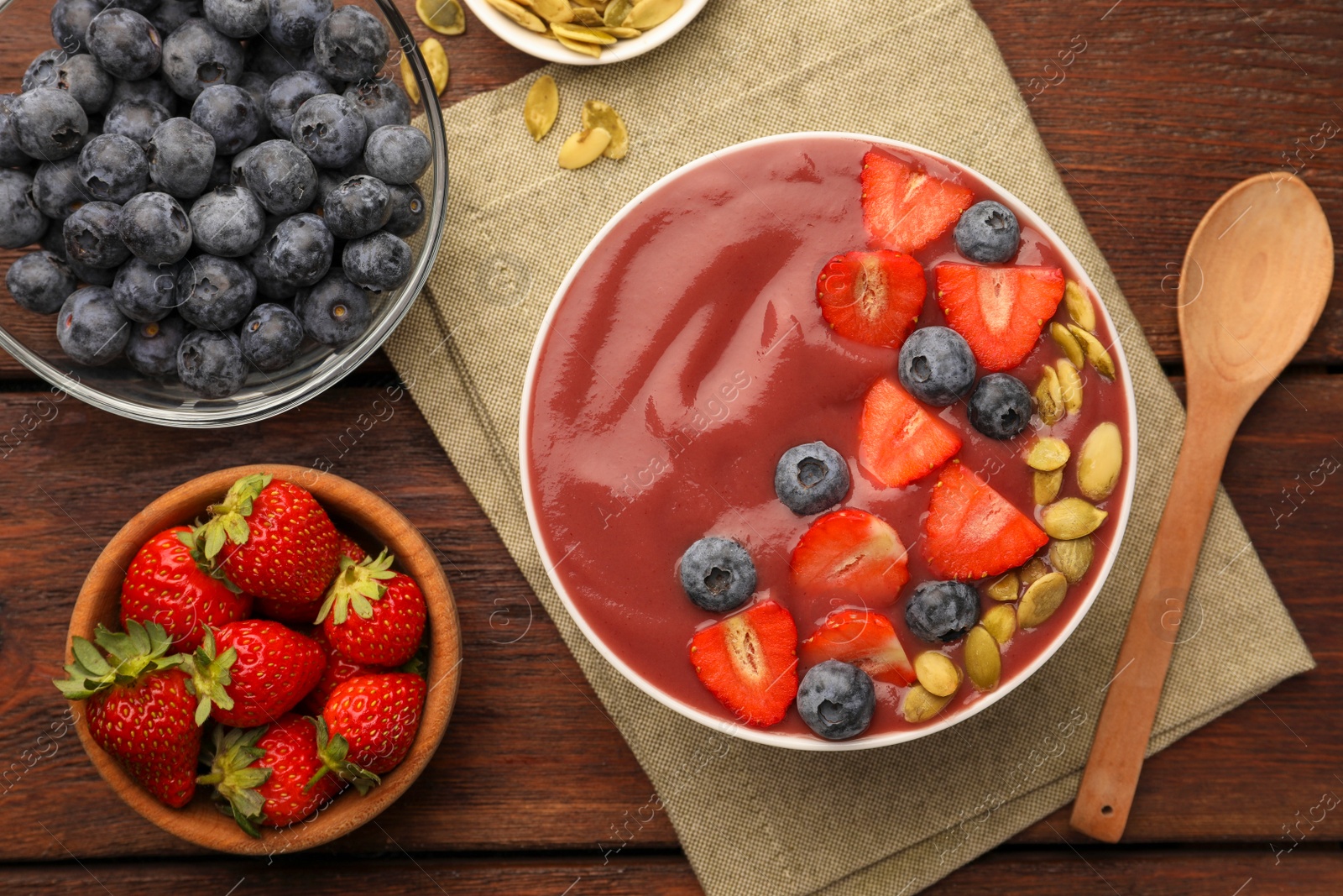 Photo of Flat lay composition with delicious smoothie and ingredients on wooden table