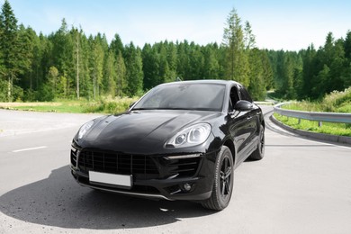 Picturesque view of modern black car on asphalt road outdoors