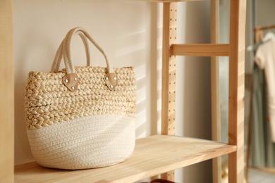 Photo of Stylish woman's bag on shelf in boutique, space for text