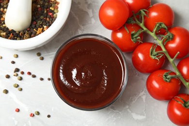 Photo of Flat lay composition with barbecue sauce and tomatoes on table