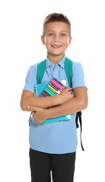 Cute little boy in school uniform with backpack and stationery on white background