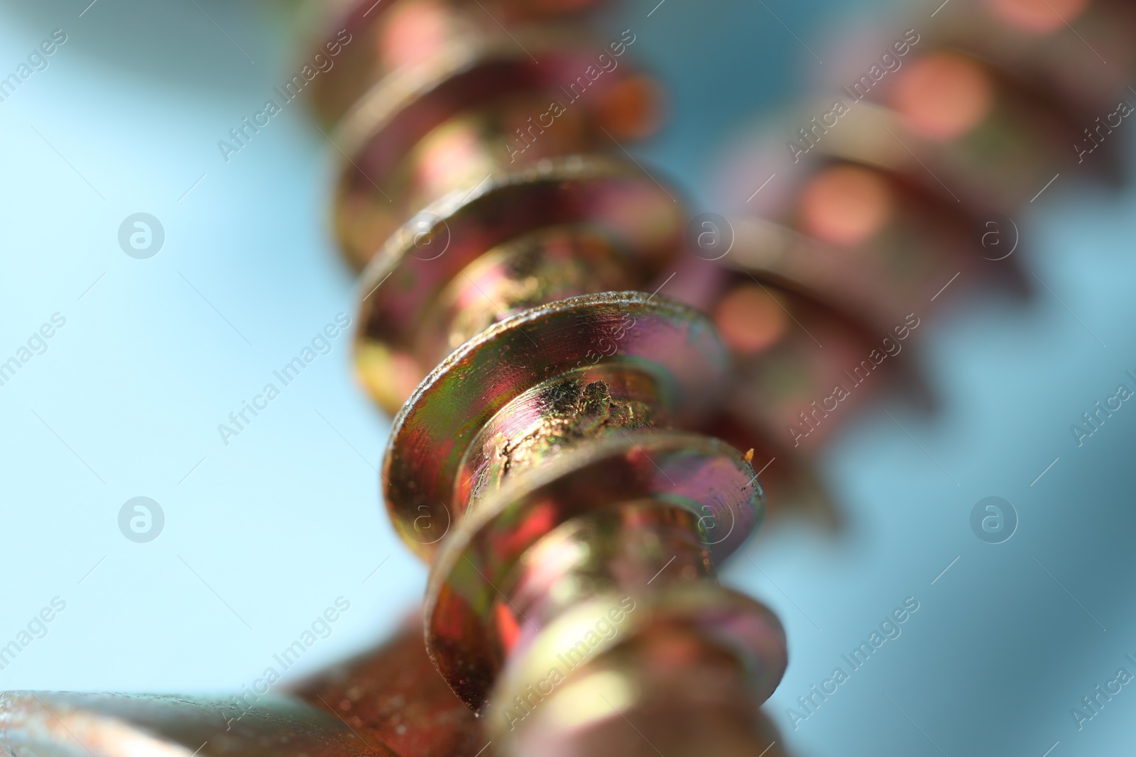 Photo of Closeup view of metal screws on blurred background