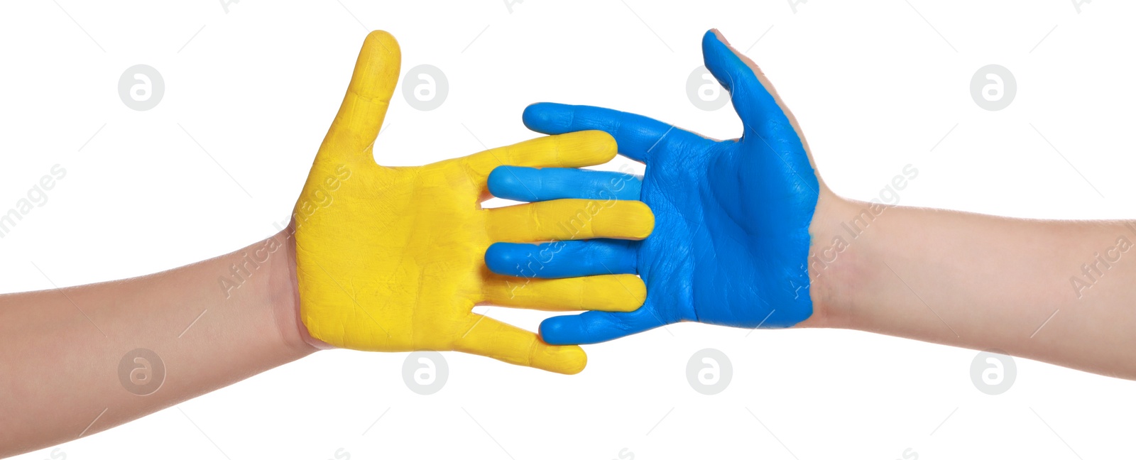 Photo of Little girl and boy with hands painted in Ukrainian flag colors on white background, closeup. Love Ukraine concept