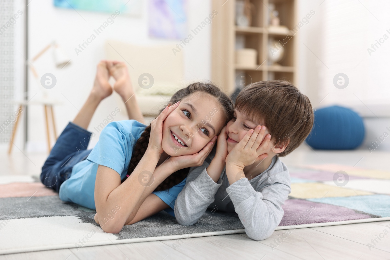 Photo of Happy brother and sister spending time together at home