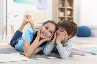 Happy brother and sister spending time together at home