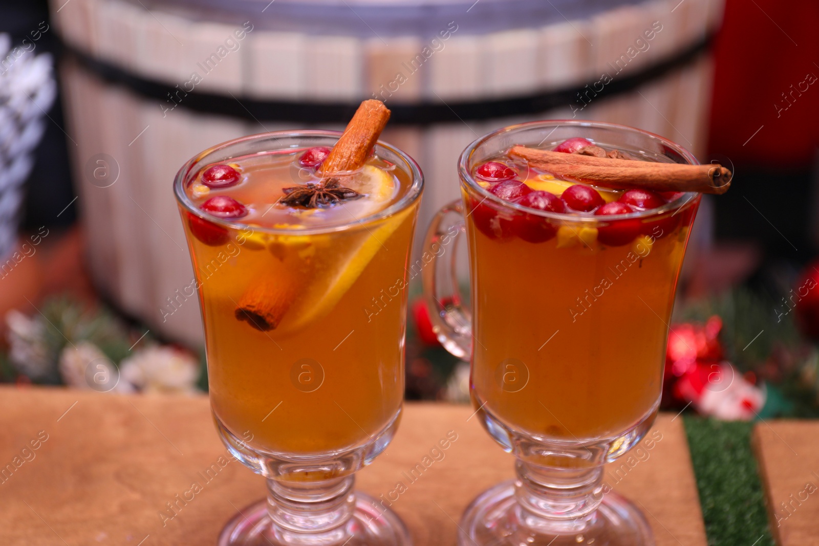 Photo of Tasty aromatic mulled wine on wooden table