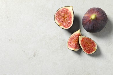 Fresh ripe figs on light table, flat lay. Space for text