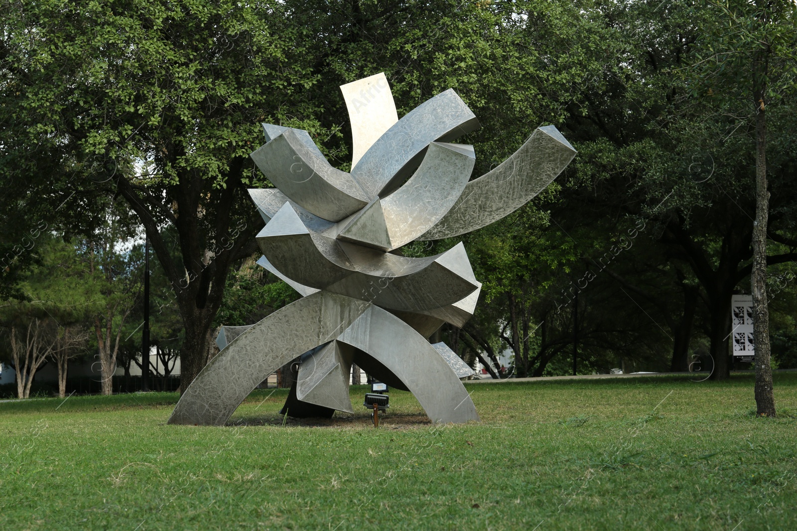 Photo of Picturesque view of beautiful park with metal figure on green grass