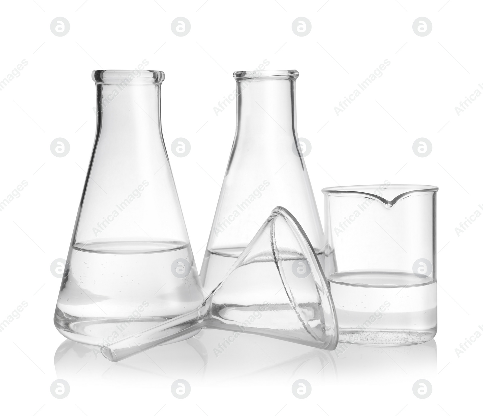 Photo of Laboratory glassware with transparent liquid on white background