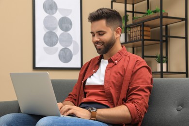 Photo of Man using laptop for online shopping at home