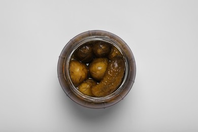 Jar of tasty pickled cucumbers on white background, top view