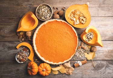 Flat lay composition with delicious homemade pumpkin pie on wooden table