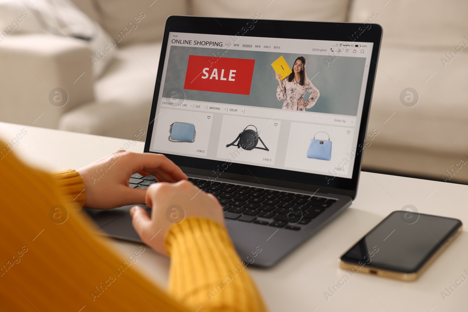 Photo of Woman shopping online during sale on laptop at home, closeup