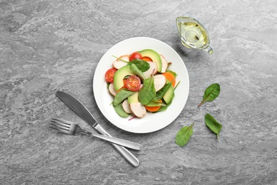 Photo of Delicious fresh chicken salad served on grey table, flat lay
