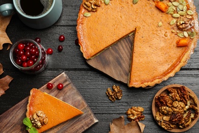 Tasty fresh homemade pumpkin pie on wooden table, flat lay