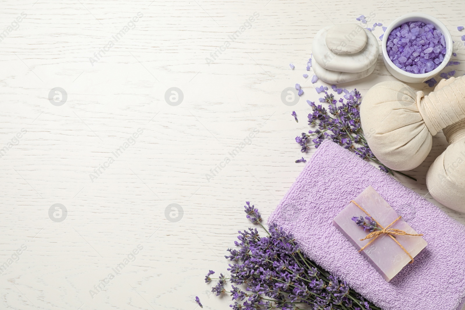 Photo of Cosmetic products and lavender flowers on white wooden background, flat lay. Space for text