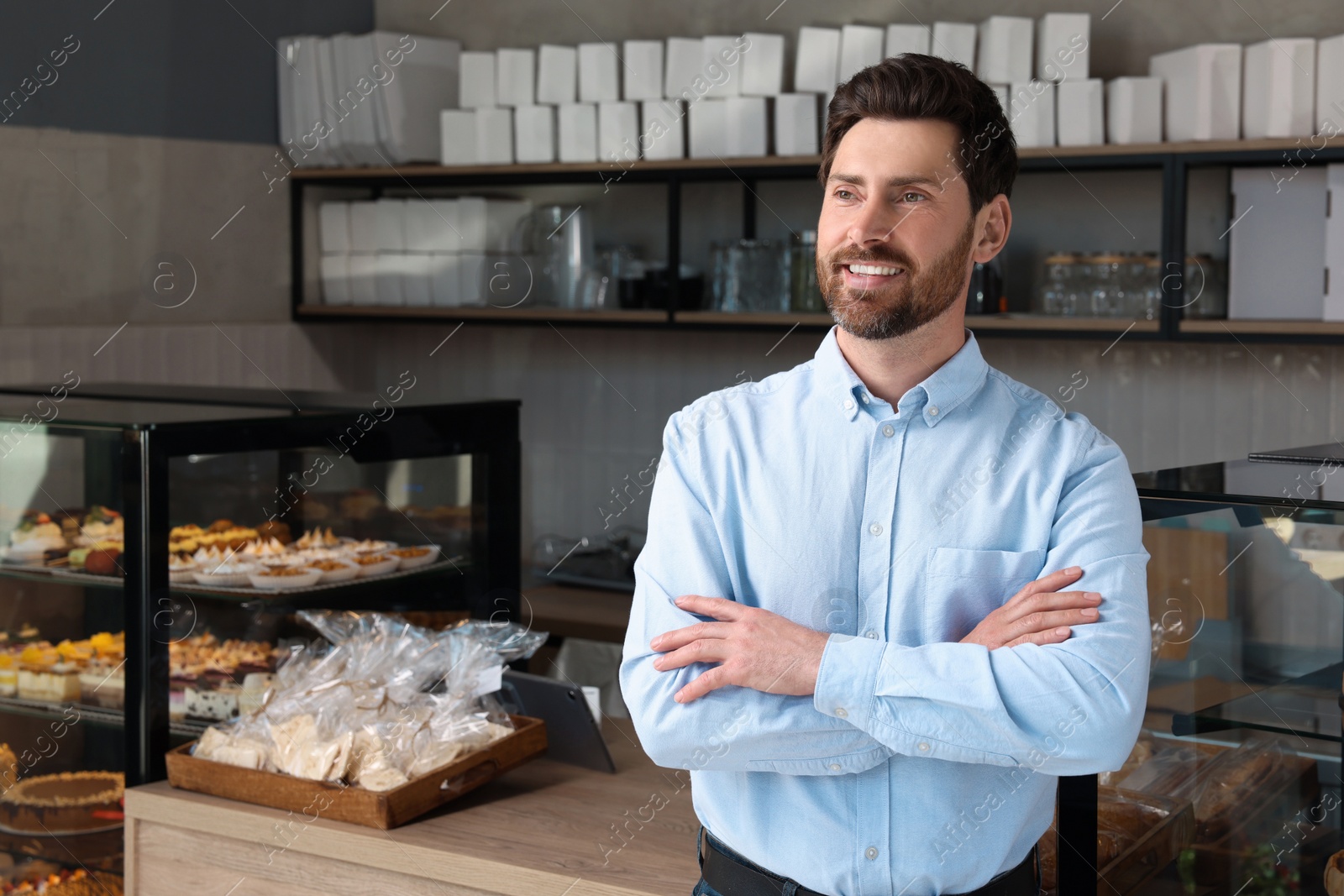 Photo of Portrait of happy business owner in bakery shop