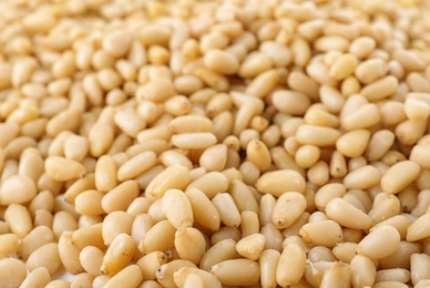 Pile of pine nuts as background, closeup