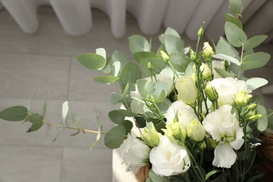Photo of Beautiful bouquet in wicker basket indoors, closeup