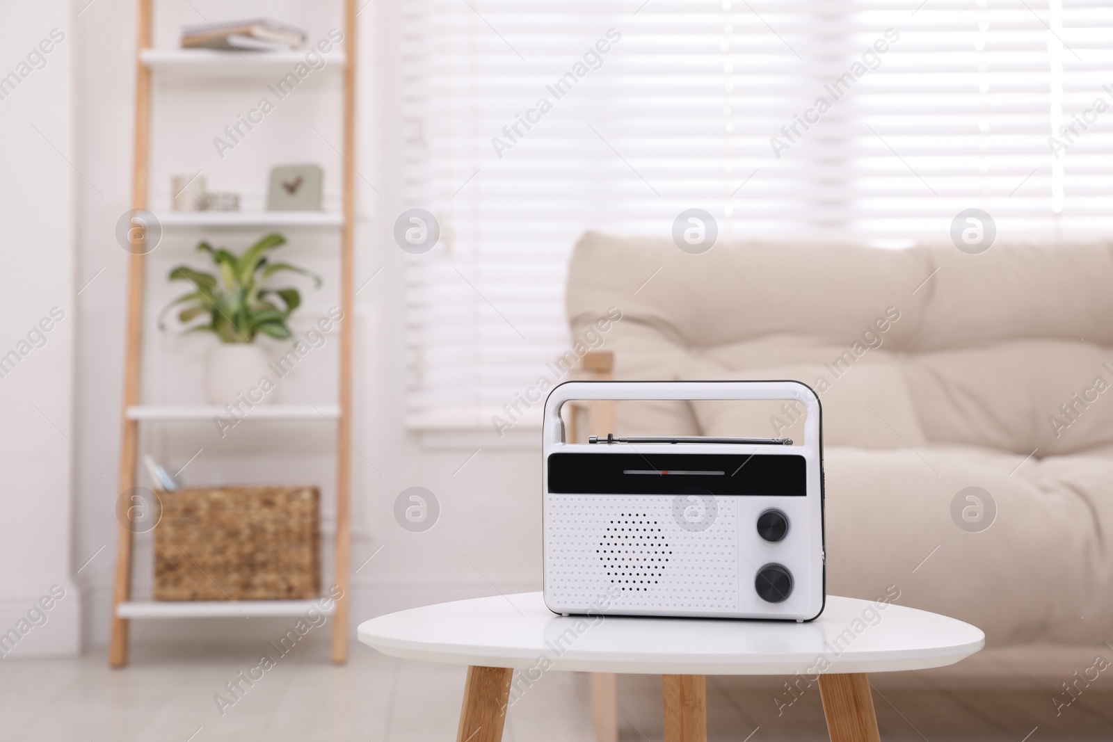 Photo of Stylish white radio on table indoors. Space for text