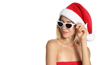 Young woman wearing Santa Claus hat on white background. Christmas vacation